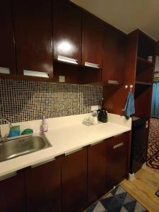 a kitchen with a sink and a counter top at Stay In Kay Kay Hotel Suite at South China Sea Place Suite in Kota Kinabalu