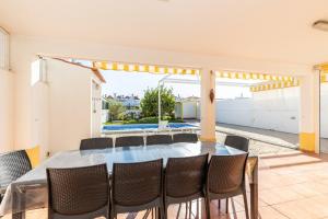 a dining room with a table and chairs at Moradia Rainbow by ALGARVEMANTA in Manta Rota