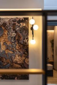 a room with a painting on the wall with lights at ARES penthouse in Thessaloniki