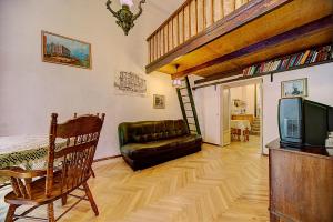 a living room with a couch and a television at Apartment Bolshaya Morskaya in Saint Petersburg