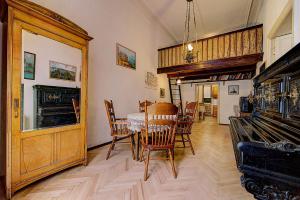 a dining room with a table and chairs at Apartment Bolshaya Morskaya in Saint Petersburg