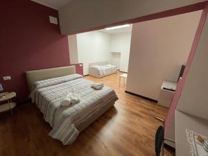 a bedroom with a bed with towels on it at Casa Per Ferie San Giovanni Bosco in La Spezia