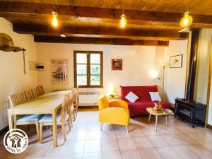 ein Wohnzimmer mit Tisch und ein Esszimmer in der Unterkunft Gîte La Petite Fagette in Frayssinet-le-Gélat