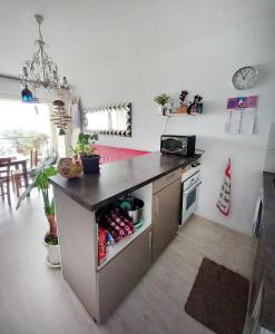 a kitchen with a counter and a stove top oven at Appartement bord de mer très lumineux 2/4 pers. - Vue inoubliable in Hendaye