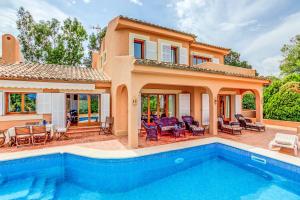 a villa with a swimming pool and a house at Villa Zahara in Alcudia
