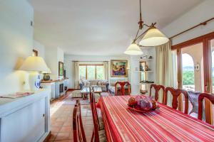 a kitchen and living room with a table and chairs at Villa Zahara in Alcudia