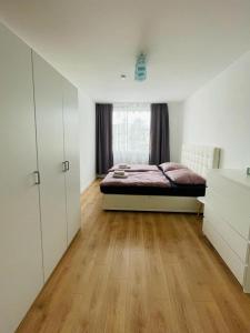 ein Schlafzimmer mit einem Bett und einem großen Fenster in der Unterkunft Appartement 202 in Klagenfurt am Wörthersee
