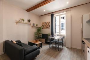 - un salon avec un canapé et une table dans l'établissement Cabana & Le Petit Carnot - Centre-Ville, à Tournus