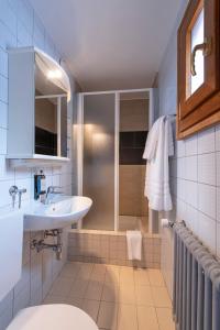 a bathroom with a sink and a shower at Hotel de La Poste in La Tzoumaz