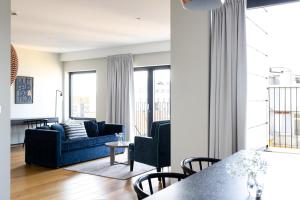 a living room with a couch and a table at Frogner House - Vika in Oslo