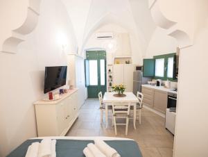 a kitchen and dining room with a table and chairs at Dimora Nonna Lina in San Michele Salentino