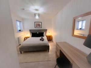a bedroom with a bed with a teddy bear on it at Gorgeous apartment with free parking in Southampton
