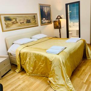 a hotel room with two beds with gold sheets at Тorino luxury с гараж in Sofia