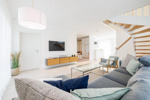 a living room with a couch and a table at Familienurlaub im Hus in de Sünn in Puddemin