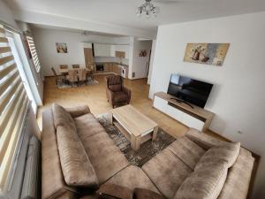 a living room with a large couch and a table at Villa Sarajevo 5 in Sarajevo