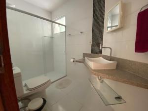 a bathroom with a shower and a toilet and a sink at Hotel APART Zuccolotto 303 in Aracruz +17 photos