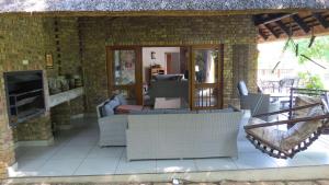 a patio with chairs and a fireplace in a house at Kruger Park Lodge - AM8 - 3 Bedroom Chalet in Hazyview