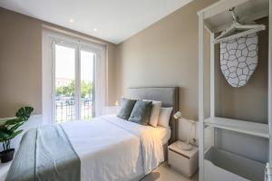 Łóżko lub łóżka w pokoju w obiekcie Apartamento Embajadores XVII