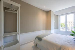 Łóżko lub łóżka w pokoju w obiekcie Apartamento Embajadores XVII