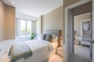 Łóżko lub łóżka w pokoju w obiekcie Apartamento Embajadores XVII