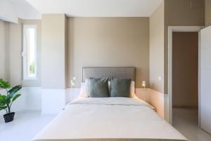 Łóżko lub łóżka w pokoju w obiekcie Apartamento Embajadores XVII