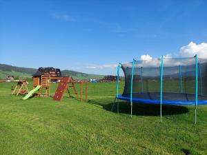 a group of playground equipment in a field at Willa u Polczyków in Białka Tatrzańska