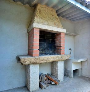 an outdoor brick oven with a stone counter top at Adosado I en Vilanova de Arousa in Villanueva de Arosa