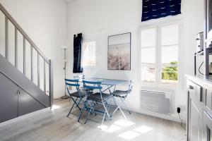 uma sala de jantar com uma mesa de vidro e cadeiras em Studio "Palombe" dans résidence avec piscine em Saint-Martin-de-Ré