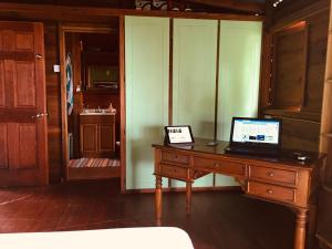 a room with a desk with a laptop on it at Large Cottage Rodney Bay 2 bedrooms 2 bathrooms in Gros Islet