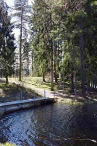 um corpo de água com uma doca numa floresta em Karstorp Säteri – Hotell och Konferens em Skövde