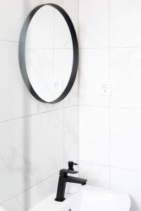 a bathroom with a mirror and a sink at Apartment Ivka in Osijek