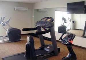 a gym with two exercise bikes and a cell phone at MainStay Suites Meridian in Meridian