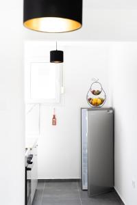 a kitchen with a refrigerator and a bowl of fruit at Apartment Ivka in Osijek
