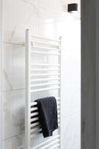 a bathroom with a shower with a towel on a rack at Apartment Ivka in Osijek