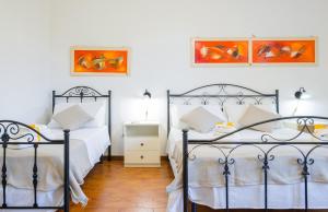 A bed or beds in a room at Villa Luritu Luxury Pool Tricase by HDSalento