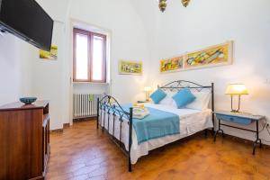 A bed or beds in a room at Villa Luritu Luxury Pool Tricase by HDSalento
