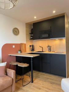 a kitchen with a sink and a counter top at Magnifique Studio Calais Plage in Calais