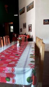 a table with a red and white table cloth on it at Familia Albahaca in Tilcara