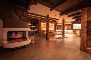 a living room with a fireplace in a house at Hotel Gissbach in Brunico