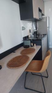 a kitchen with two chairs and a counter top at Studio Vila Mariana in Sao Paulo