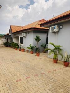 a building with potted plants in front of it at Our Nice Home in Kaduna