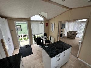 a kitchen and living room with a table and chairs at Ingoldmells Sunnymede I14 in Ingoldmells