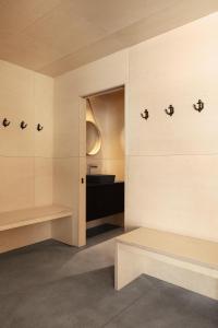 a room with white walls and benches and a window at Cabine A in Petite-Rivière-Saint-François