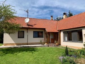 a house with an orange roof and a yard at Chalupa Lužnice in Třeboň