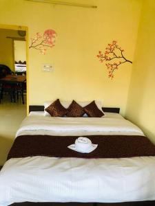 a bedroom with a bed with a hat on it at The Emerald House in Varanasi