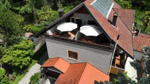 an aerial view of a house with umbrellas at Nora s Home 1 - Panoramic Terrace & Bio Garden in Merano