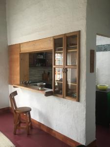 a kitchen with a counter and a chair in a room at Casa típica de la Región del Café in Calarcá