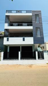 ein großes Gebäude mit Buchstabe a darauf in der Unterkunft Navile Apartments in Chikmagalur