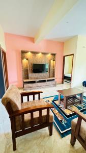 salon z kanapą i stołem w obiekcie Navile Apartments w mieście Chikmagalur