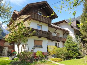 a house in the mountains with a balcony at Gästehaus zum Gachtna in Mayrhofen